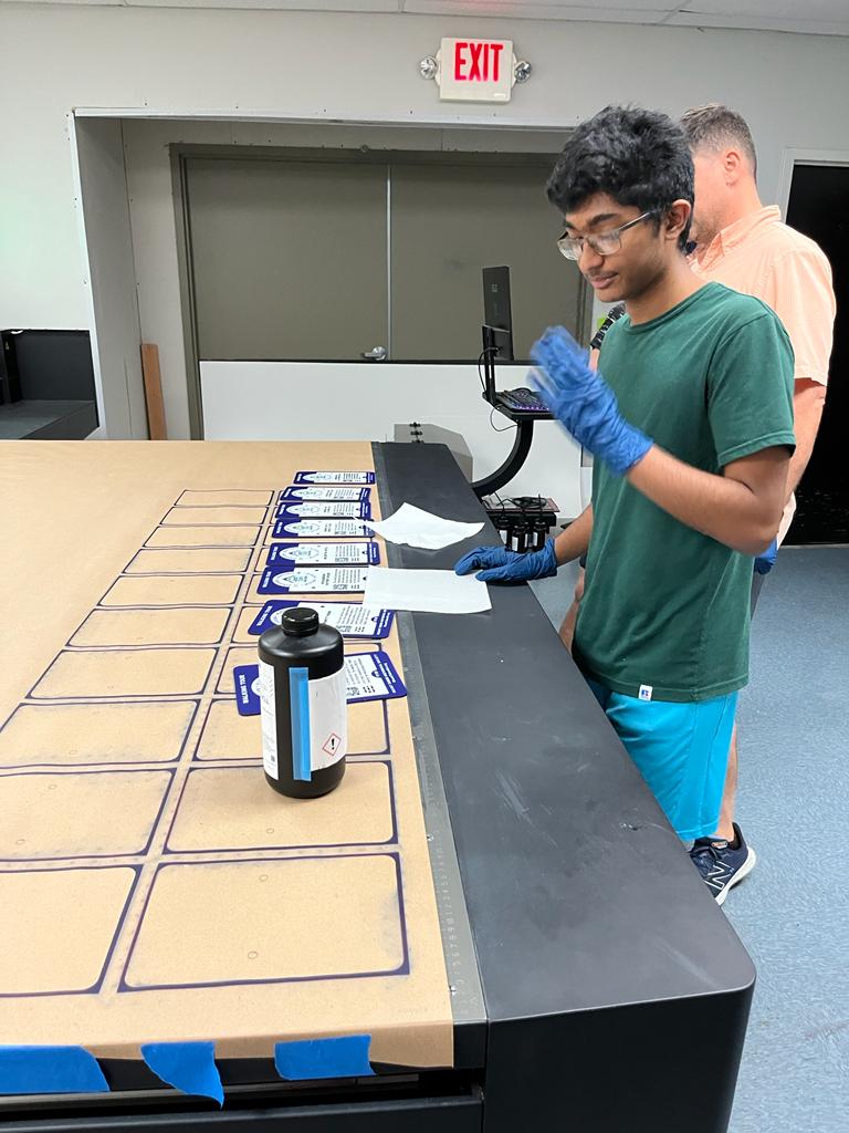 Preparing printed sign faces during the production process.